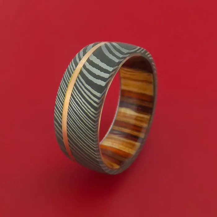 Damascus Steel Ring with 14k Rose Gold Inlay and Interior Hardwood Sleeve Custom Made Band Lashbrook Rings Damascus Steel Ring with 14k Rose Gold Inlay and Interior Hardwood Sleeve Custom Made Band Lashbrook Rings